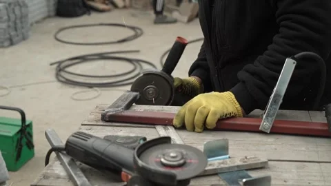Worker cutting metal tube using an Angle Grinder. Bright sparks and flashes Stock Footage 259027726