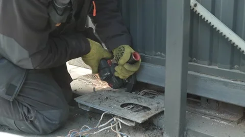 Worker cutting metal tube using an Angle Grinder. Bright sparks and flashes Video stock 259027752