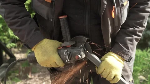 Worker cutting metal tube using an Angle Grinder. Bright sparks and flashes Video stock 259027769