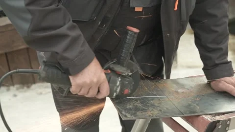 Worker cutting metal tube using an Angle Grinder. Bright sparks and flashes Stock Footage 259027787