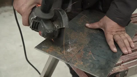 Worker cutting metal tube using an Angle Grinder. Bright sparks and flashes Stock Footage 259027791