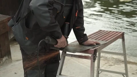 Worker cutting metal tube using an Angle Grinder. Bright sparks and flashes Video stock 259027792