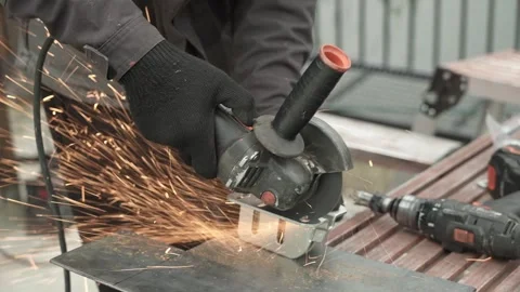 Worker cutting metal tube using an Angle Grinder. Bright sparks and flashes Stock Footage 259027818