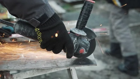 Worker cutting metal tube using an Angle Grinder. Bright sparks and flashes Stock-Footage 261527995