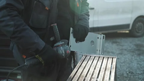 Worker cutting metal tube using an Angle Grinder. Bright sparks and flashes Video stock 261528191