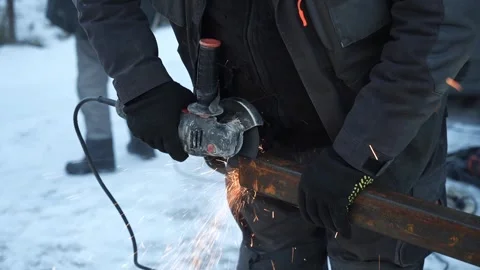 Worker cutting metal tube using an Angle Grinder. Bright sparks and flashes Stock Footage 263186507
