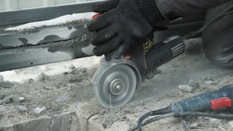 Worker cutting metal tube using an Angle Grinder. Bright sparks and flashes Video stock 263186510