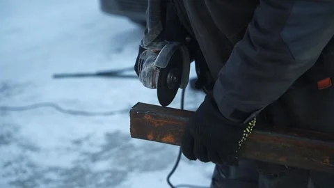 Worker cutting metal tube using an Angle Grinder. Bright sparks and flashes Stock Footage 263186512