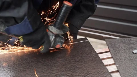 Worker cutting metal tube using an Angle Grinder. Bright sparks and flashes Stock Footage 263186557