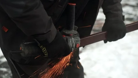 Worker cutting metal tube using an Angle Grinder. Bright sparks and flashes Video stock 263186566