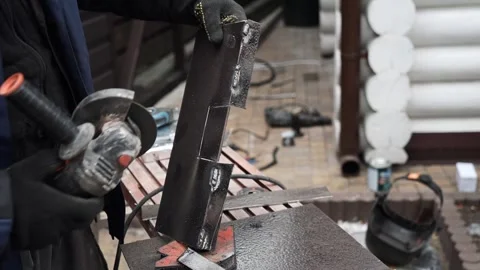 Worker cutting metal tube using an Angle Grinder. Bright sparks and flashes Stock Footage 263186567