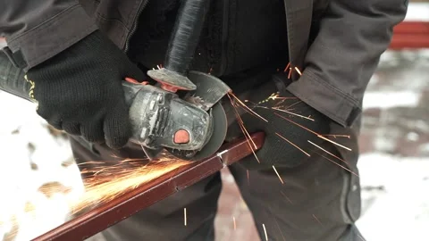 Worker cutting metal tube using an Angle Grinder. Bright sparks and flashes Stock Footage 263186569