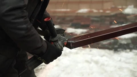 Worker cutting metal tube using an Angle Grinder. Bright sparks and flashes Stock Footage 263186570