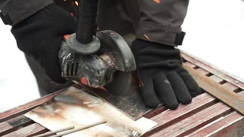 Worker cutting metal tube using an Angle Grinder. Bright sparks and flashes Stock Footage 263186582