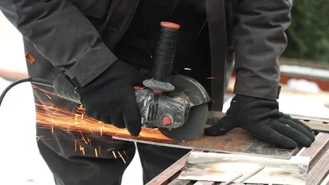 Worker cutting metal tube using an Angle Grinder. Bright sparks and flashes Stock Footage 263186583