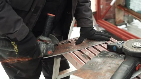 Worker cutting metal tube using an Angle Grinder. Bright sparks and flashes Stock Footage 263186598