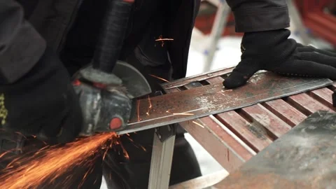 Worker cutting metal tube using an Angle Grinder. Bright sparks and flashes Video stock 263186603