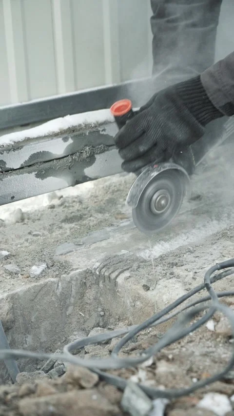 Worker cutting metal tube using an Angle Grinder. Bright sparks and flashes Stock-Footage 263186604