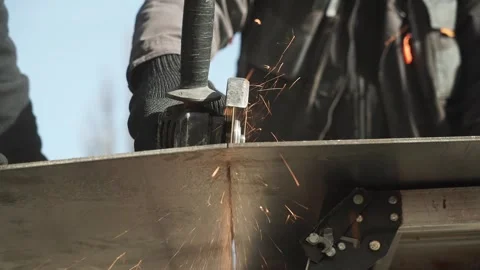 Worker cutting metal tube using an Angle Grinder. Bright sparks and flashes Stock Footage 266806124