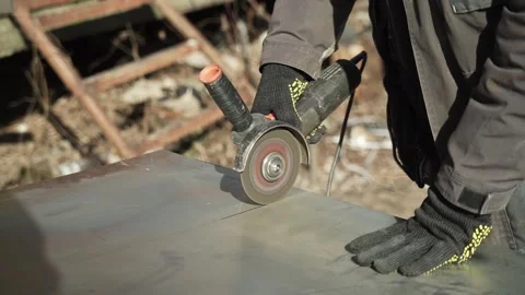 Worker cutting metal tube using an Angle Grinder. Bright sparks and flashes Stock Footage 266806146