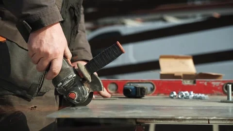 Worker cutting metal tube using an Angle Grinder Stock Footage 268794574