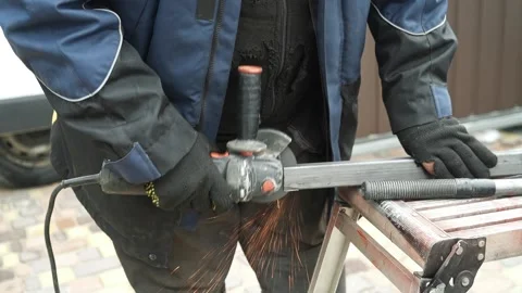 Worker cutting metal tube using an Angle Grinder Stock Footage 268794575