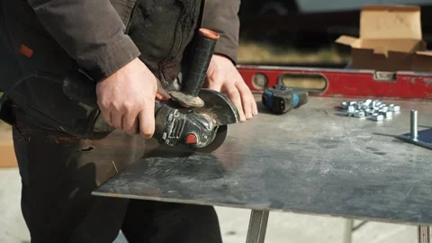 Worker cutting metal tube using an Angle Grinder Stock Footage 268794576