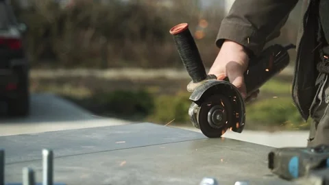 Worker cutting metal tube using an Angle Grinder Stock Footage 268794583