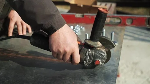 Worker cutting metal tube using an Angle Grinder Stock Footage 268794593