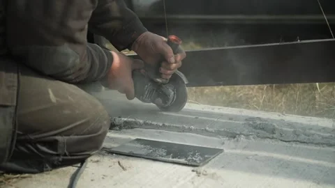 Worker cutting metal tube using an Angle Grinder Stock Footage 268794594