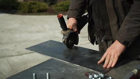 Worker cutting metal tube using an Angle Grinder Stock Footage 268794602