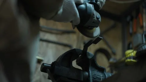 Worker cutting metal tube using an Angle Grinder. Bright sparks and flashes Stock Footage 302490990