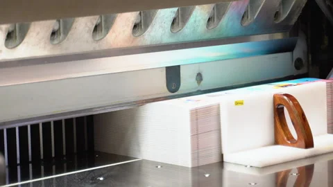 Worker cutting paper using paper cutting machine in a printing factory Stock Footage 257030326