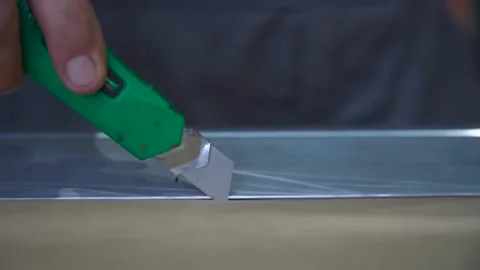 Worker Cutting Paper with a Utility Knife. Worker's hand cutting a paper templat 스톡 동영상 294263702