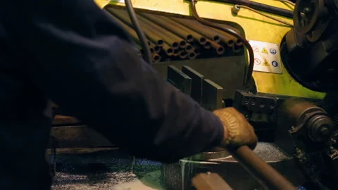 Worker cutting a pipe on contour band saw Stock Footage 100607003