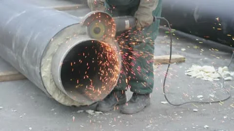 Worker cutting pipe with grinder Stock Footage 8997095