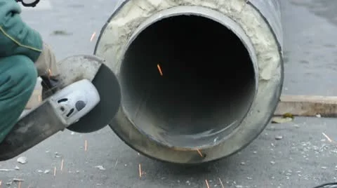 Worker cutting pipe with grinder Stock Footage 8997112