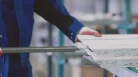 Worker cutting PVC profile with circular saw Stock Footage 68887616