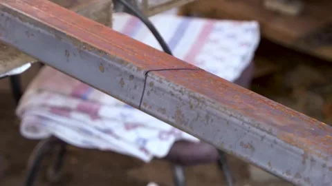 Worker cutting rectangular steel tube with an angle grinder tool creating sparks Stock-Footage 262803014