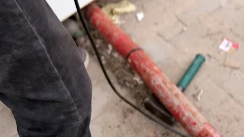 Worker Cutting Rusty Metal Pipe With Angle Grinder and Flying Sparks Stock Footage 332545745