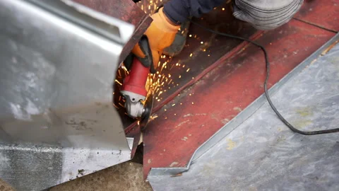 Worker cutting sheet metal with angle grinder Stock Footage 158974676