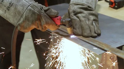 Worker cutting sheet of metal with plasma cutter Stock Footage 248715194