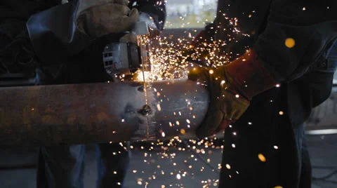 Worker Cutting Steel Pipe with Angle Grinder Stock Footage