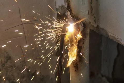 Worker cutting steel pipe using metal torch Stock Photos