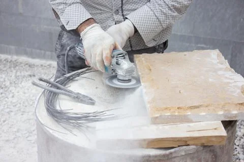 Worker cutting stone block by cutter machine. Stock Photos
