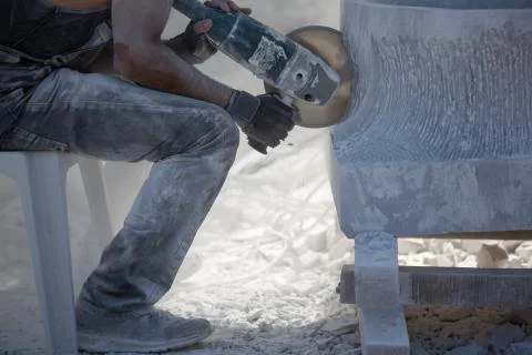Worker cutting stone with grinder Stock Photos