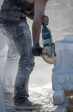 Worker cutting stone with grinder 스톡 사진