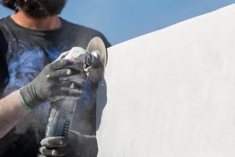 Worker cutting stone with grinder Stock Photos