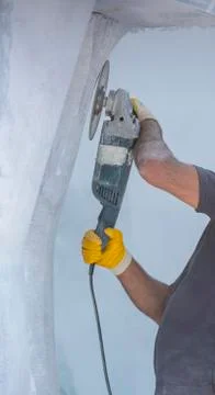 Worker cutting stone with grinder 스톡 사진