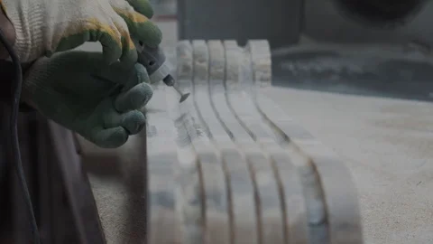 Worker cutting stone plate with professional tools, creates an ornament of the f Stock Footage 99039060